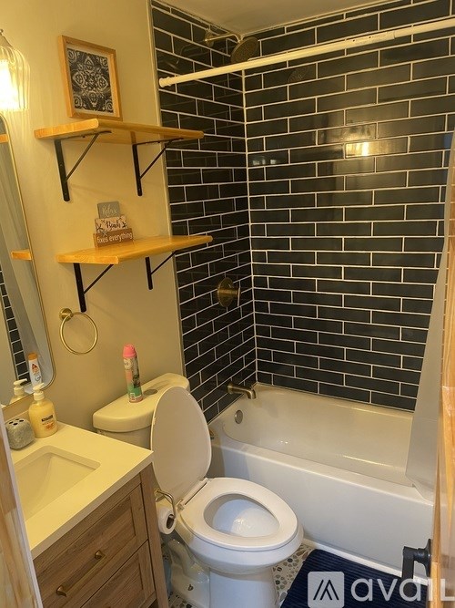 A bathroom with a toilet, sink, and a bathtub.