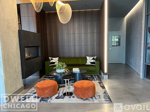 A modern living room with a green couch and a fireplace.