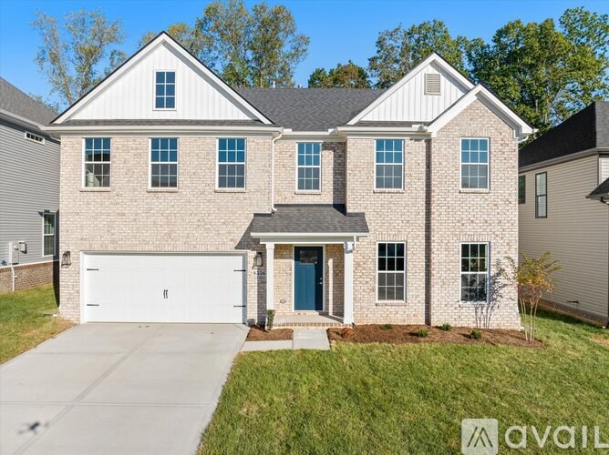 A house with a white garage door and a blue door is for sale.