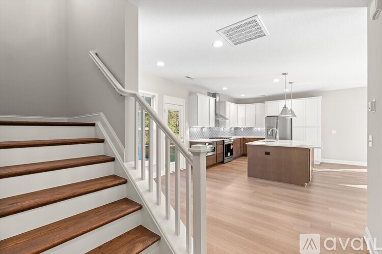 A modern interior of a house with a staircase leading to the upper floor.
