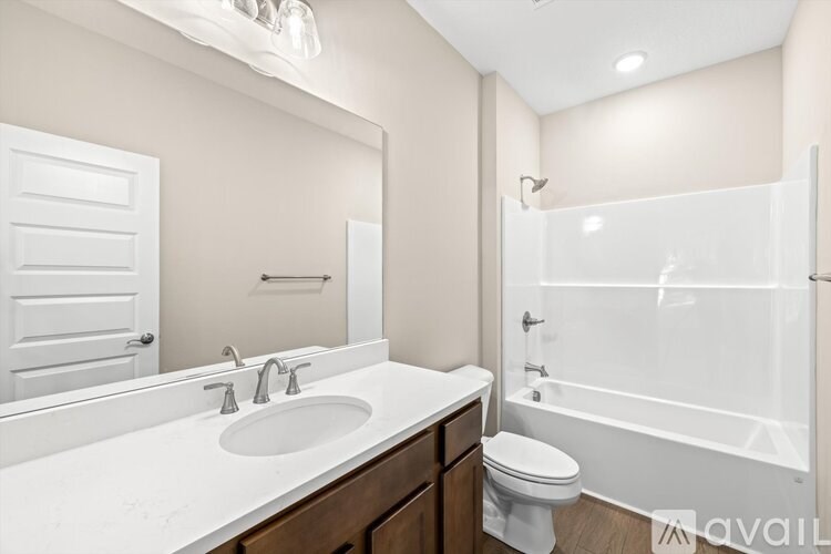 A bathroom with a white sink, toilet, and bathtub.