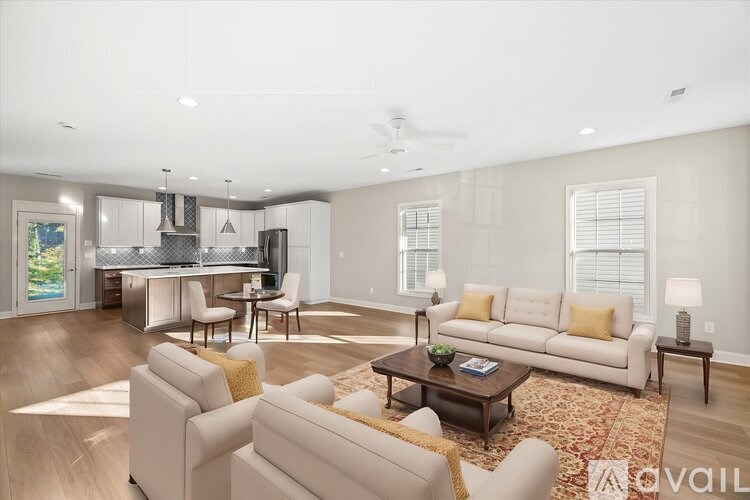 A living room with a white couch and a coffee table.