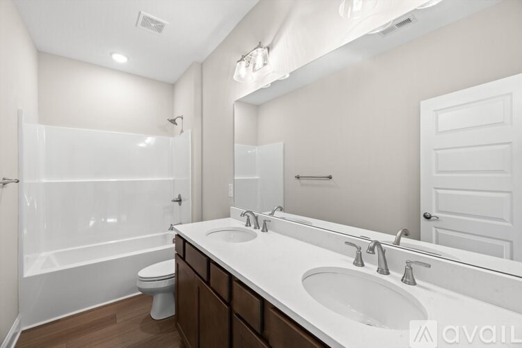 A bathroom with a white sink, toilet, and bathtub.
