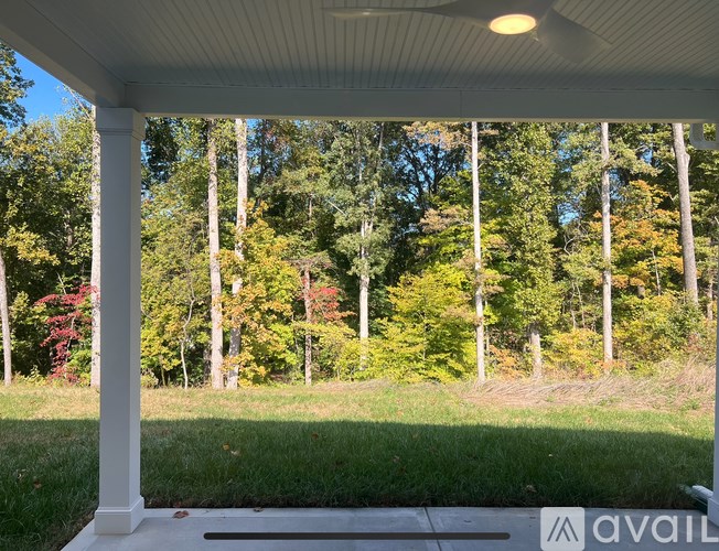 A porch with a view of a forest.