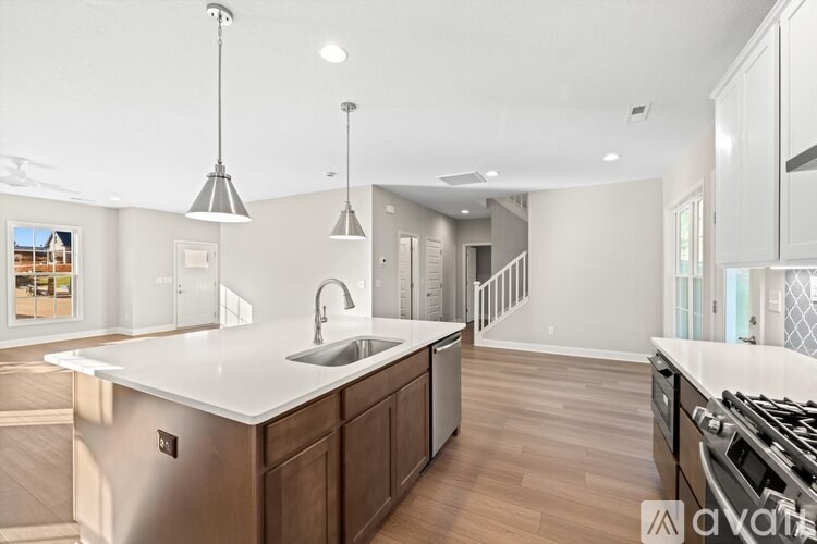 A modern kitchen with a large island and stainless steel appliances.
