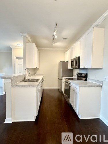 A kitchen with white cabinets and appliances.