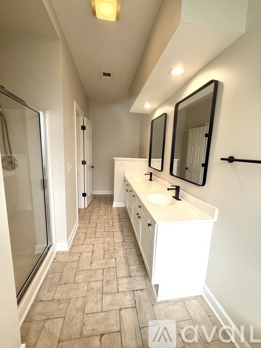 A bathroom with a sink and mirrors.