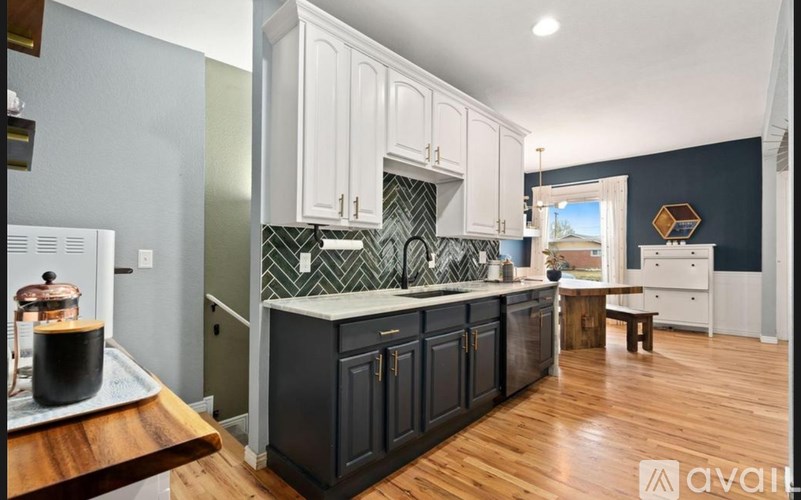 A kitchen with dark cabinets and a wooden counter.