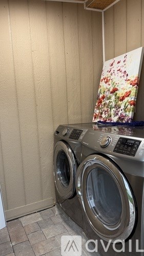 Two front loading washing machines in a laundry room.