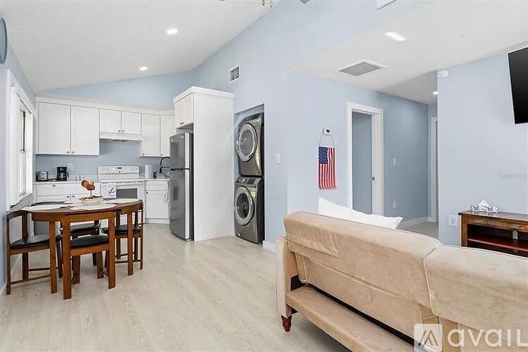 A kitchen with a dining table and a couch.