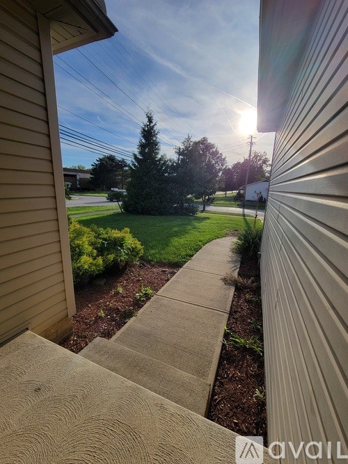A house with a wooden staircase leading to the front door.