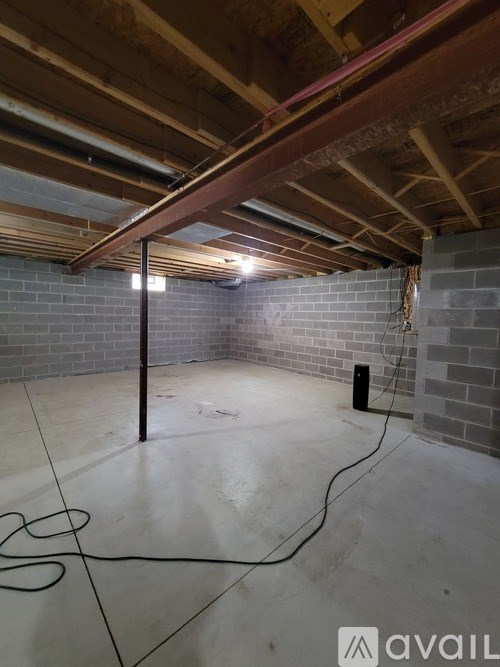 A room with a brick wall and a wooden beam on the ceiling.