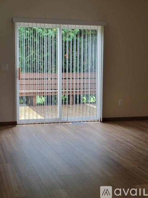 A room with a sliding door leading to a balcony.
