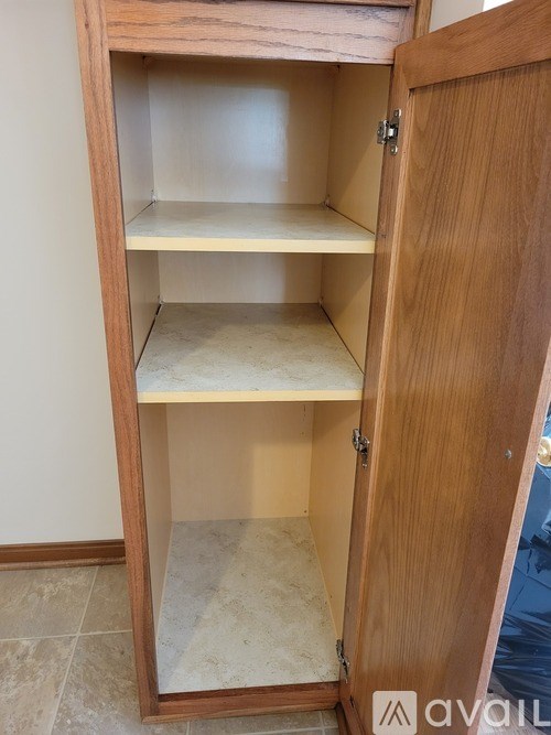 A wooden cabinet with two shelves is open.