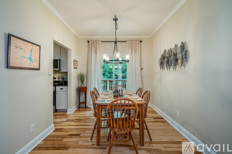A dining room with a wooden table and chairs.