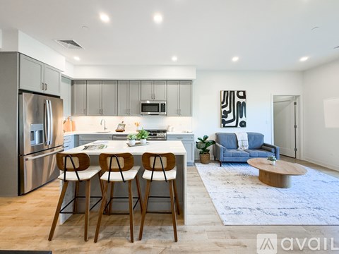 A modern kitchen with a dining table and chairs.