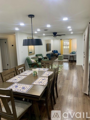 A dining room with a table set for a meal.