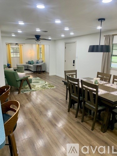 A living room with a dining table and chairs.
