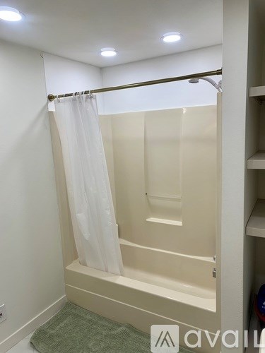 A small white bathroom with a shower curtain.