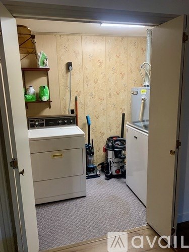 A small laundry room with a washer and dryer.