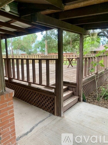 A wooden deck with a lattice design on the bottom.