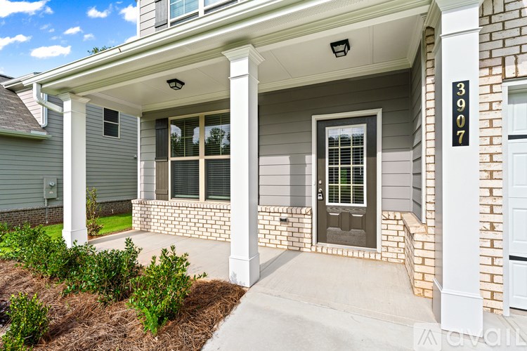 A house numbered 3907 with a white door and windows.