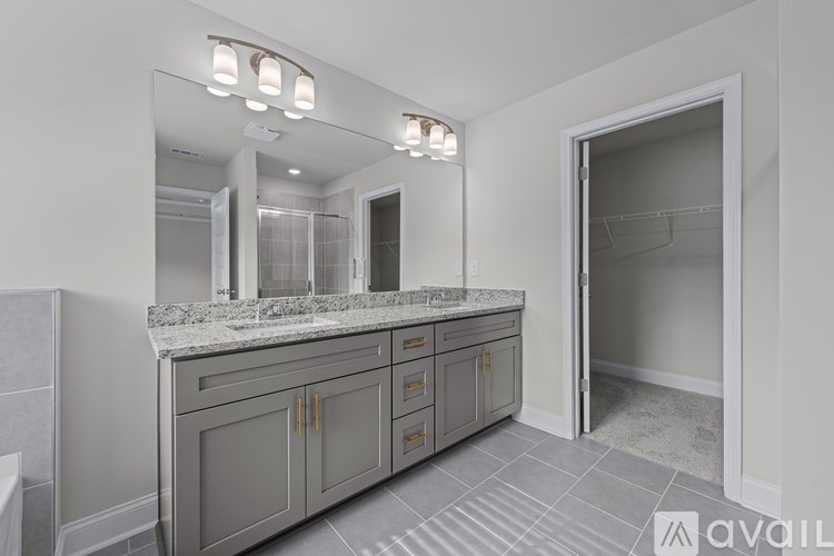 A bathroom with a vanity and a large mirror.