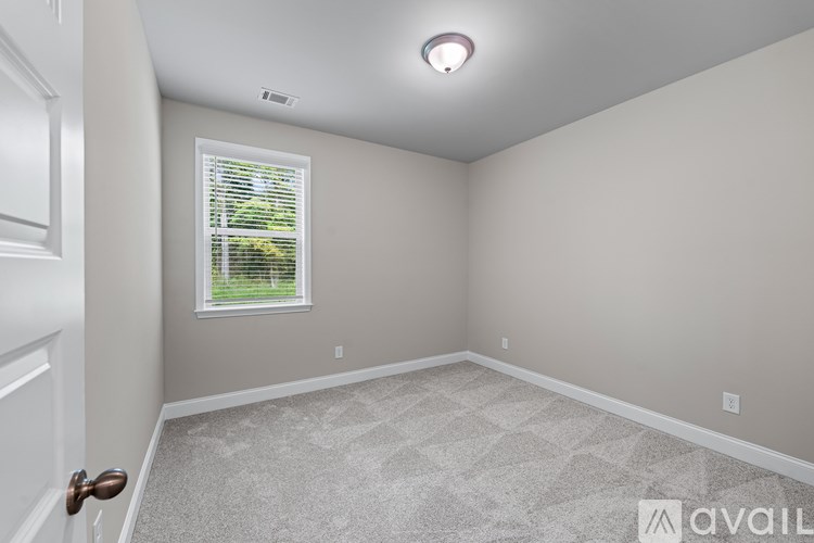 A room with a window and a door.