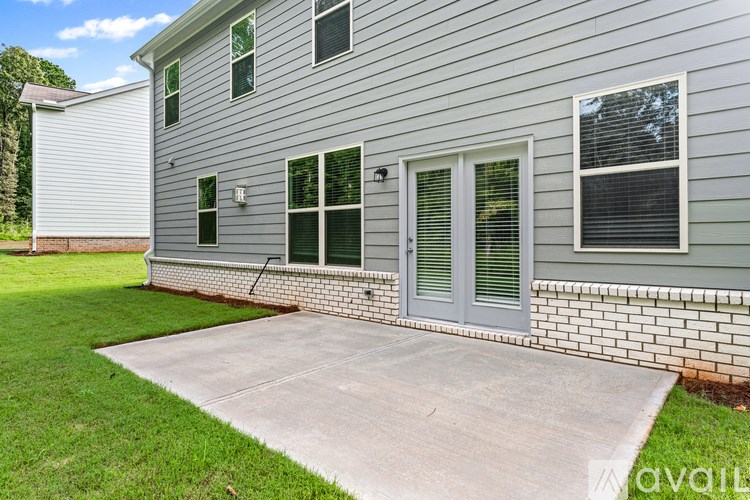 A house with a grey siding and a white garage door.