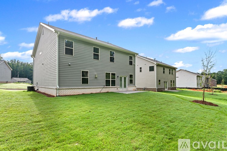 A house with a large lawn in front of it.