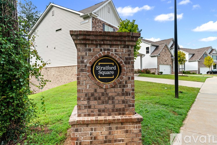 A sign for Stratford Square is in front of a house.