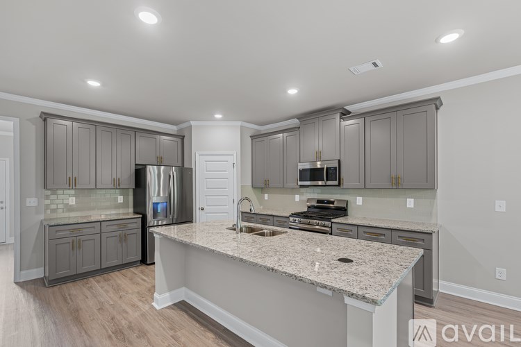 A kitchen with granite countertops and stainless steel appliances.