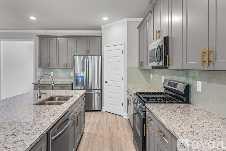 A kitchen with granite countertops and stainless steel appliances.