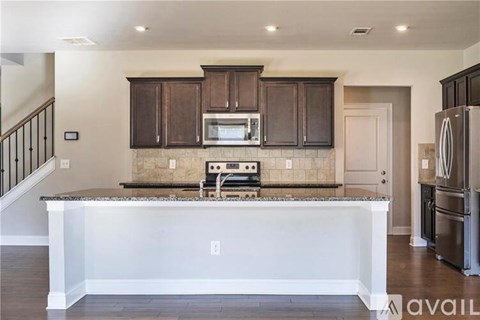A kitchen with brown cabinets and a white island.