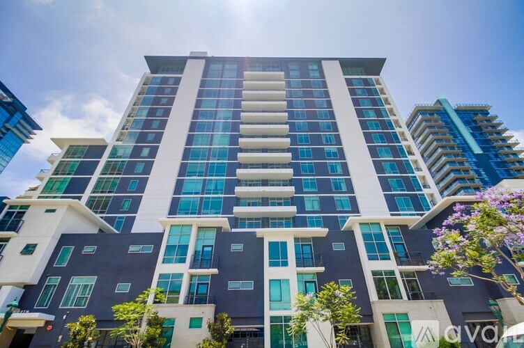 A tall building with a blue sky in the background.