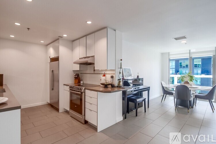 A modern kitchen with a dining area and a view of the city.