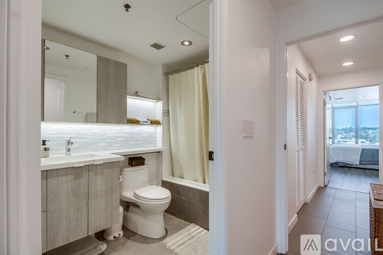 A bathroom with a toilet, sink, and bathtub.