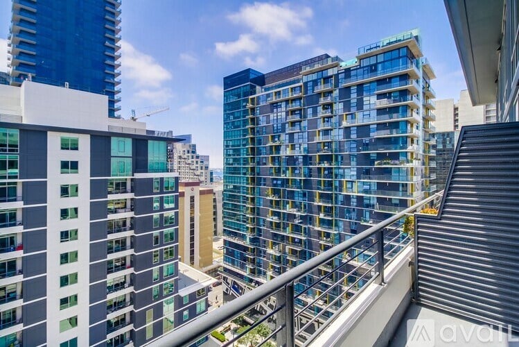 A balcony overlooks a cityscape with various buildings.