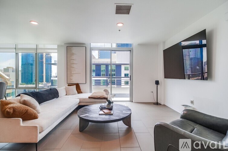 A modern living room with a large window overlooking the city.