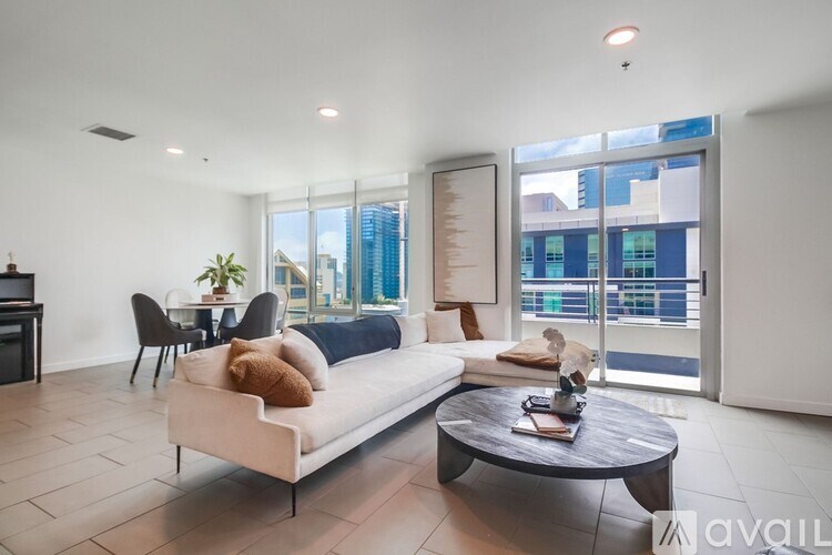 A modern living room with a white sofa and a coffee table.