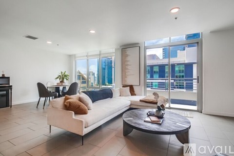 A modern living room with a white sofa and a coffee table.