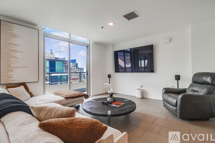 A living room with a large window overlooking a cityscape.