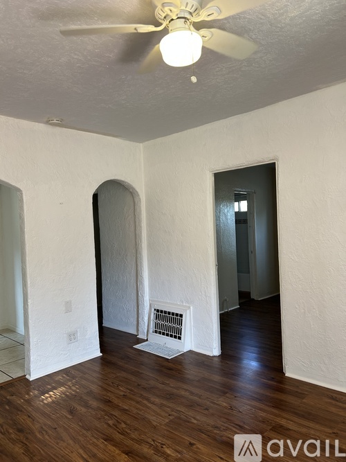 A hallway with a white door and a window.