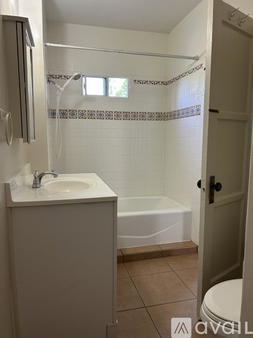 A room with a ceiling fan and a light hanging from it.