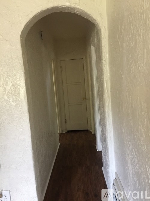 A hallway with a door at the end.