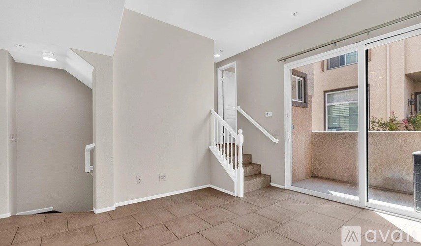 A room with a staircase leading to a balcony.