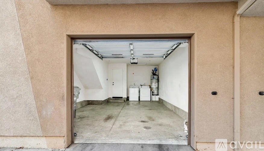 A large open garage door with a white interior.