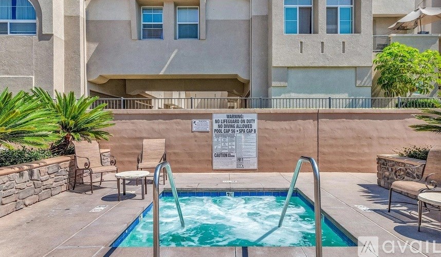 A pool with a sign that says "WARNING: DIVING ALLOWED NO FINS, SPEARS OR CHEST WARMERS".