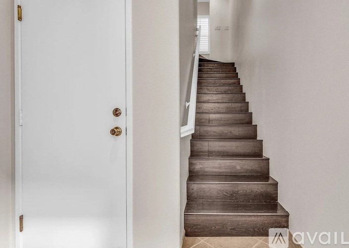 A staircase with a white door on the side.