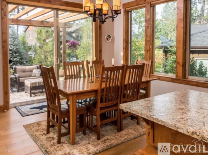 A dining room with a table and chairs.